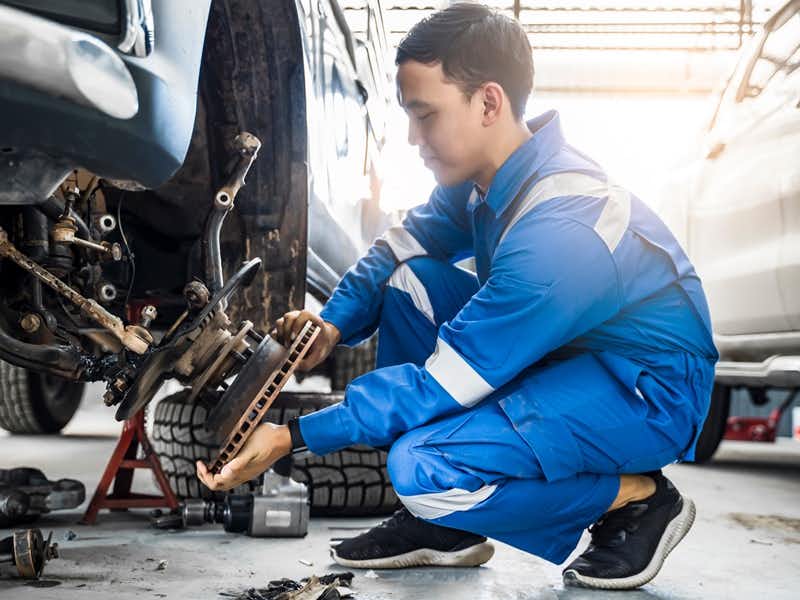 Checking Front Wheels And Tires Is Part Of Yearly Motor Maintenance
